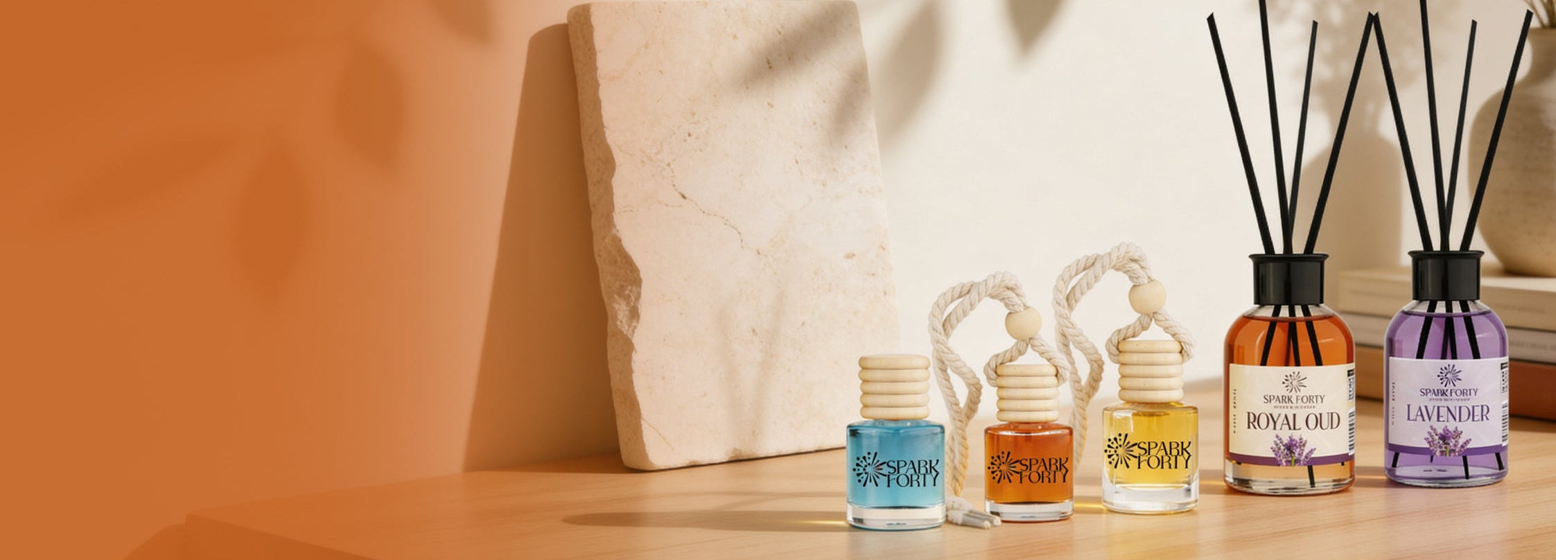 Sparkforty home and car fragrance collection featuring Royal Oud and Lavender reed diffusers alongside premium hanging car perfumes
